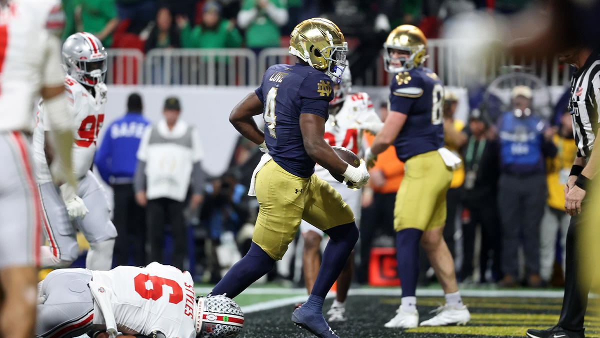 Notre Dame Fighting Irish running back Jeremiyah Love (4) scores a two-point conversion against the Ohio State Buckeyes during the second half the CFP National Championship college football game at Mercedes-Benz Stadium.