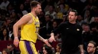 Los Angeles Lakers guard Luka Doncic (77) high fives head coach JJ Redick during the first quarter against the Brooklyn Nets at Barclays Center.