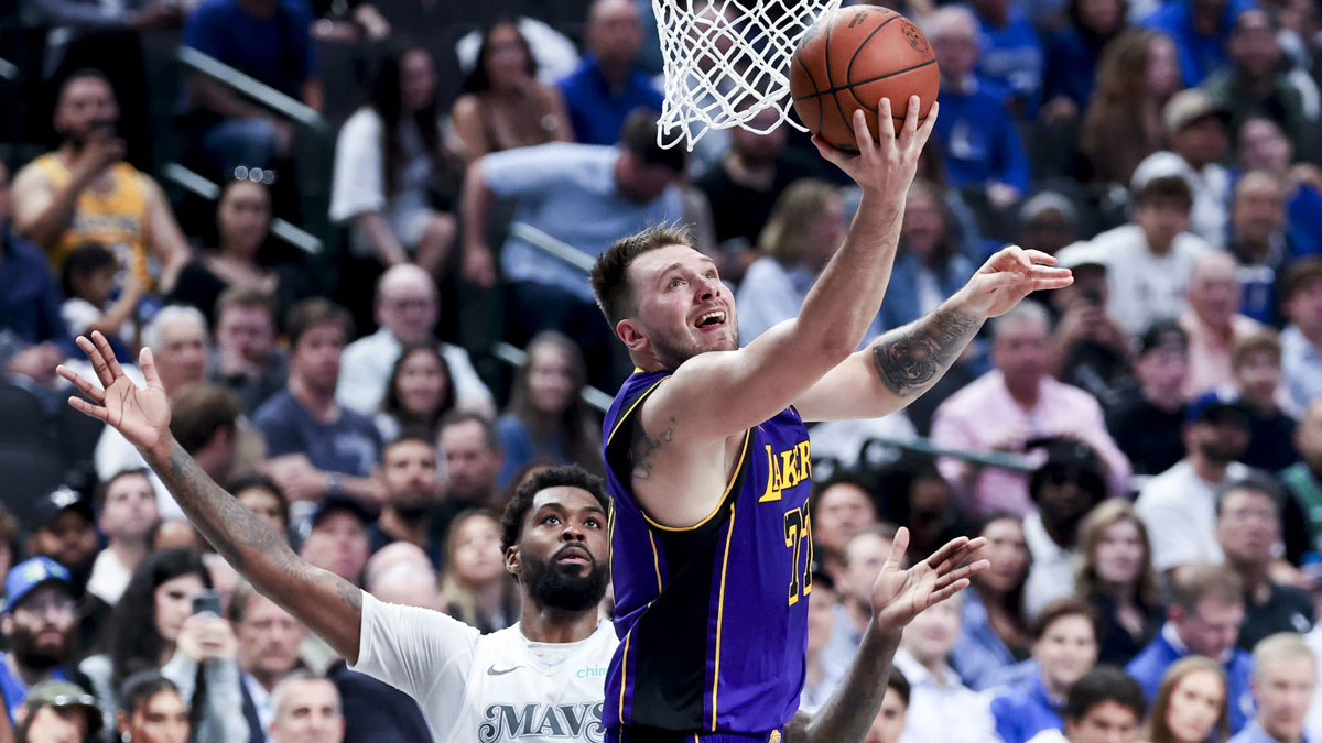 The Los Angeles Lakers goalkeeper Luka Doncic (77), passed the Dallas Mavericks striker, Naji Marshall (13) in the second quarter to the American Airlines Center.