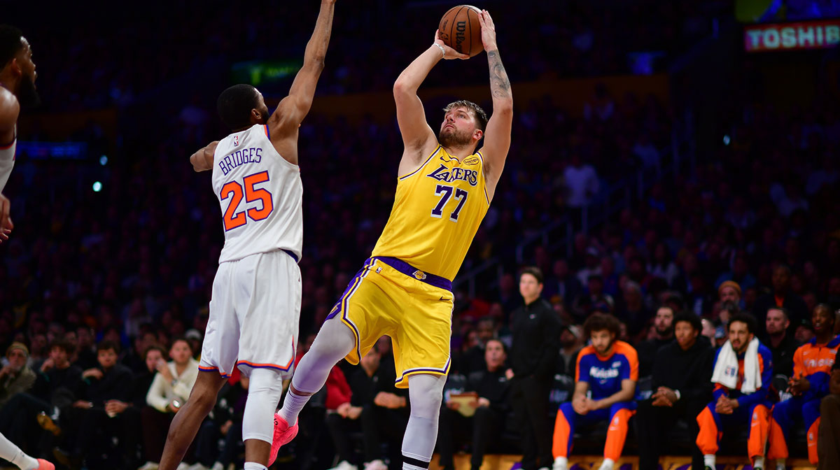 Los Angeles Lakers guard Luka Doncic (77) shoots against New York Knicks forward Mikal Bridges (25) during the second half at Crypto.com Arena. Mandatory Credit: