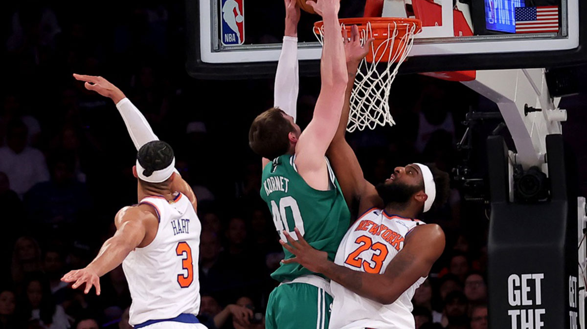 Boston Celtics center Luke Kornet (40) dunks against New York Knicks center Mitchell Robinson (23) and guard Josh Hart (3) during the second quarter of game six in the second round of the 2025 NBA Playoffs at Madison Square Garden.