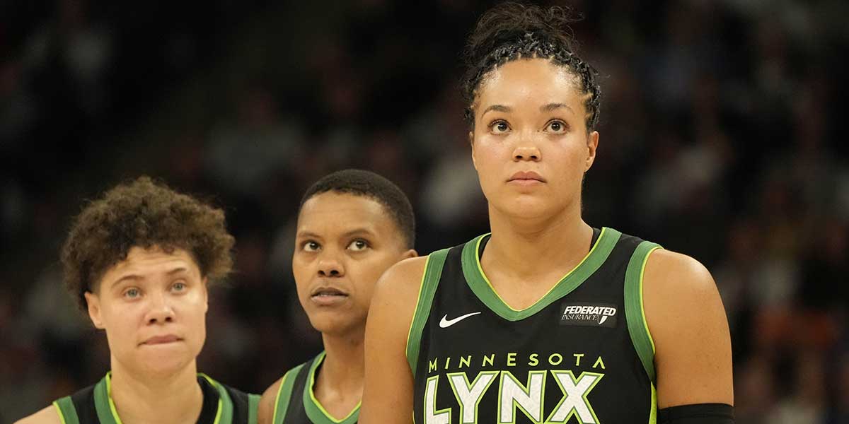 Minnesota Lynx guard Natisha Hiedeman, guard Courtney Williams, and forward Napheesa Collier watch a free throw in the third quarter against the Dallas Wings at Target Center.