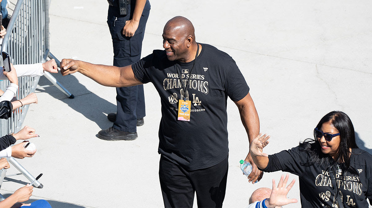 Los Angeles Dodgers minority owner and former Los Angeles Laker Magic Johnson arrives at Dodger Stadium for the team’s World Series Championship celebration.