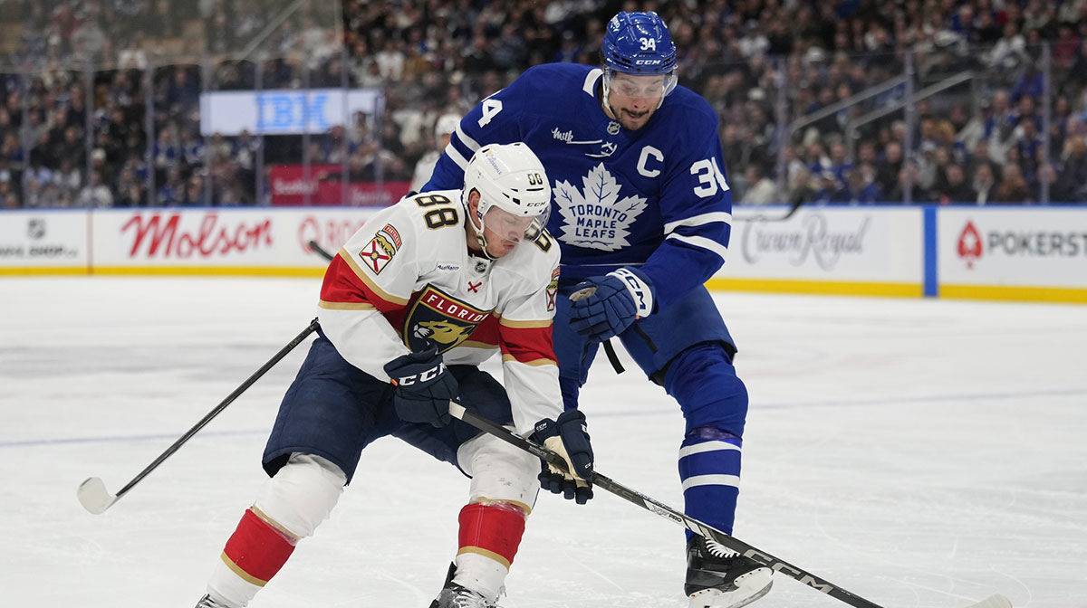 Florida Panthers defenseman Nate Schmidt (88) and Toronto Maple Leafs forward Auston Matthews (34) battle for the puck during the first period at Scotiabank Arena.