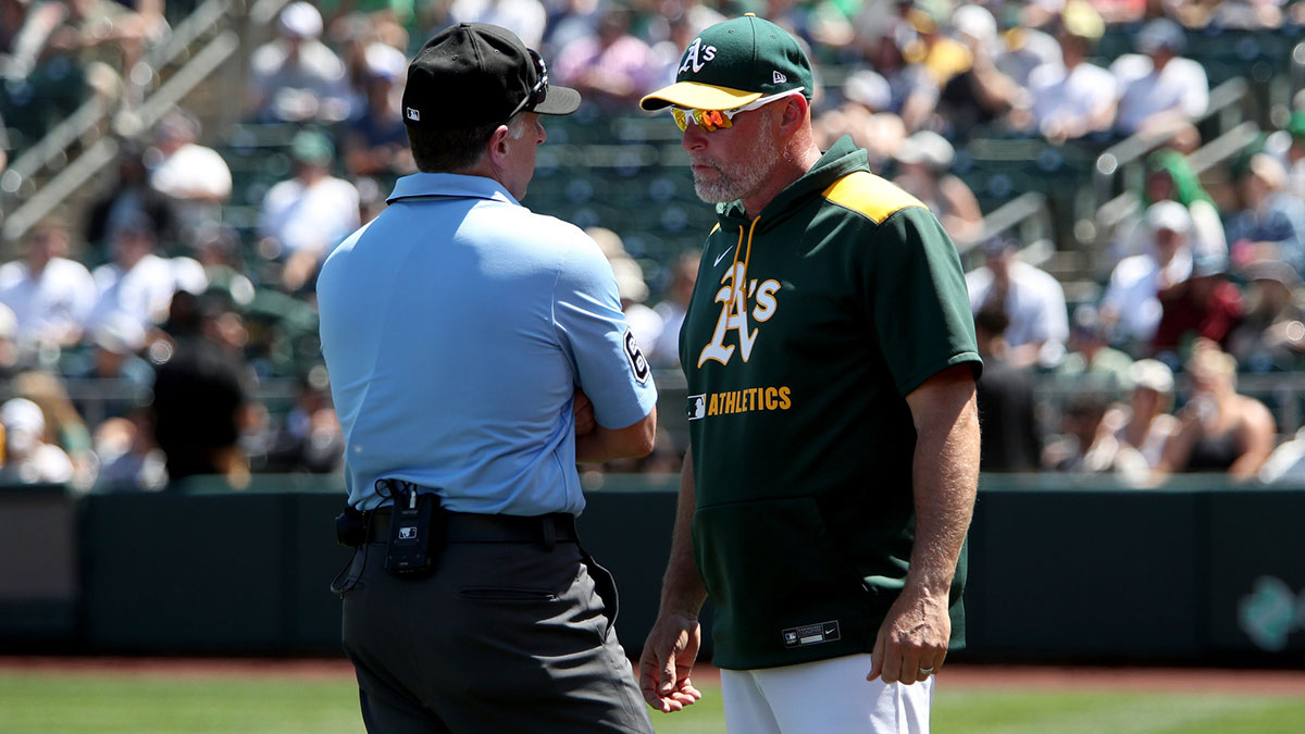 Athletics manager Mark Kotsay (7) meets with an umpire to discuss a call against the New York Yankees during the fifth inning at Sutter Health Park.