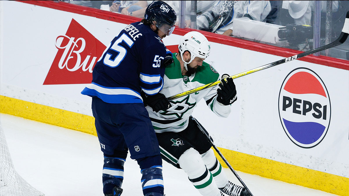 Winnipeg Jets forward Mark Scheifele (55) battles Dallas Stars forward Jamie Benn (14) for the puck during the third period in game one of the second round of the 2025 Stanley Cup Playoffs at Canada Life Centre.