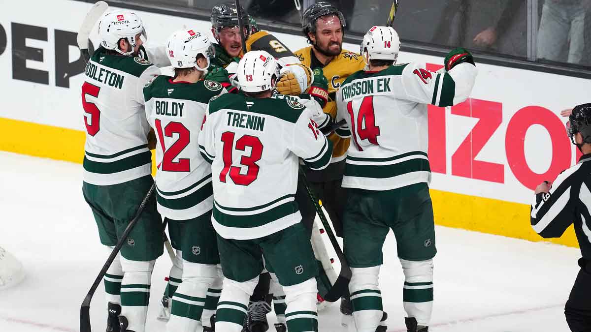 Vegas Golden Knights center Jack Eichel (9) and right wing Mark Stone (61) scrum with Minnesota Wild defenseman Jake Middleton (5), left wing Matt Boldy (12), center Yakov Trenin (13), and center Joel Eriksson Ek (14) during the third period of game five of the first round of the 2025 Stanley Cup Playoffs at T-Mobile Arena.
