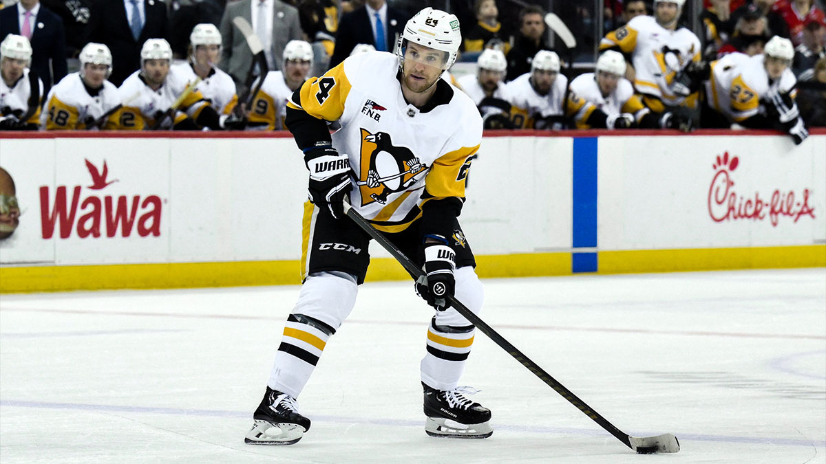 Pittsburgh Penguins defenseman Matt Grzelcyk (24) controls the puck during the third period against the New Jersey Devils at Prudential Center.
