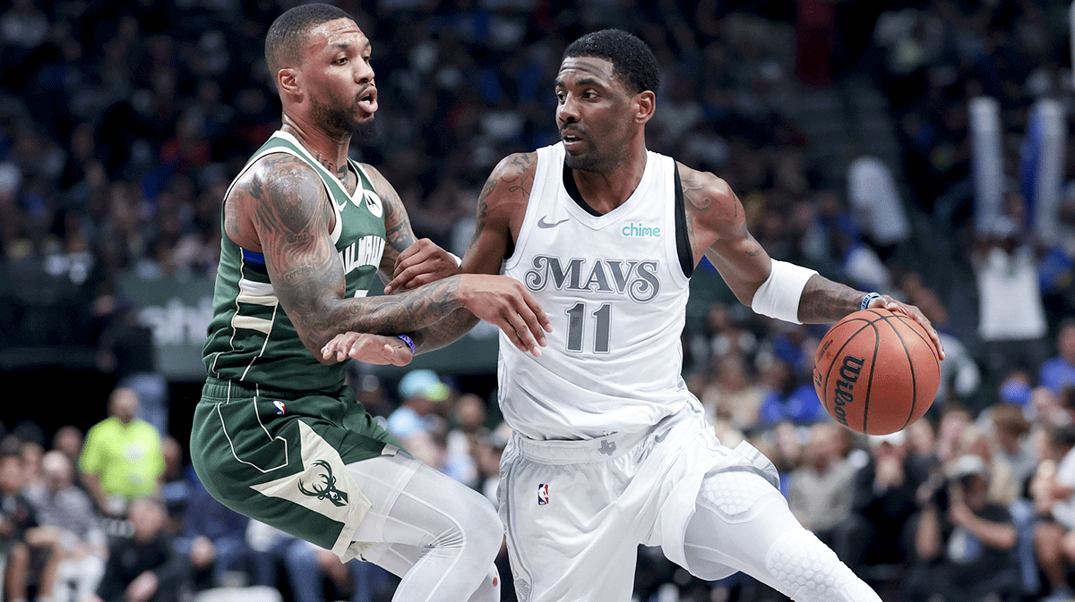 Dallas Mavericks guard Kyrie Irving (11) controls the ball as Milwaukee Bucks guard Damian Lillard (0) defends during the first half at American Airlines Center