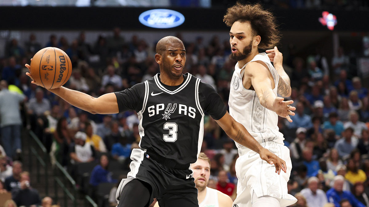 San Antonio Spurs guard Chris Paul (3) passes around Dallas Mavericks center Dereck Lively II (2) during the first half at American Airlines Center.