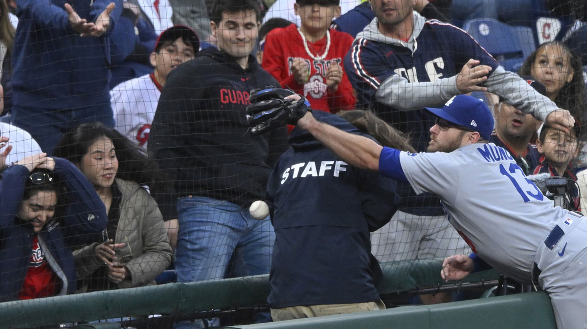 Los Angeles Dodgers third baseman Max Muncy (13) reaches for a foul ball in the seventh inning against the Cleveland Guardians at Progressive Field.
