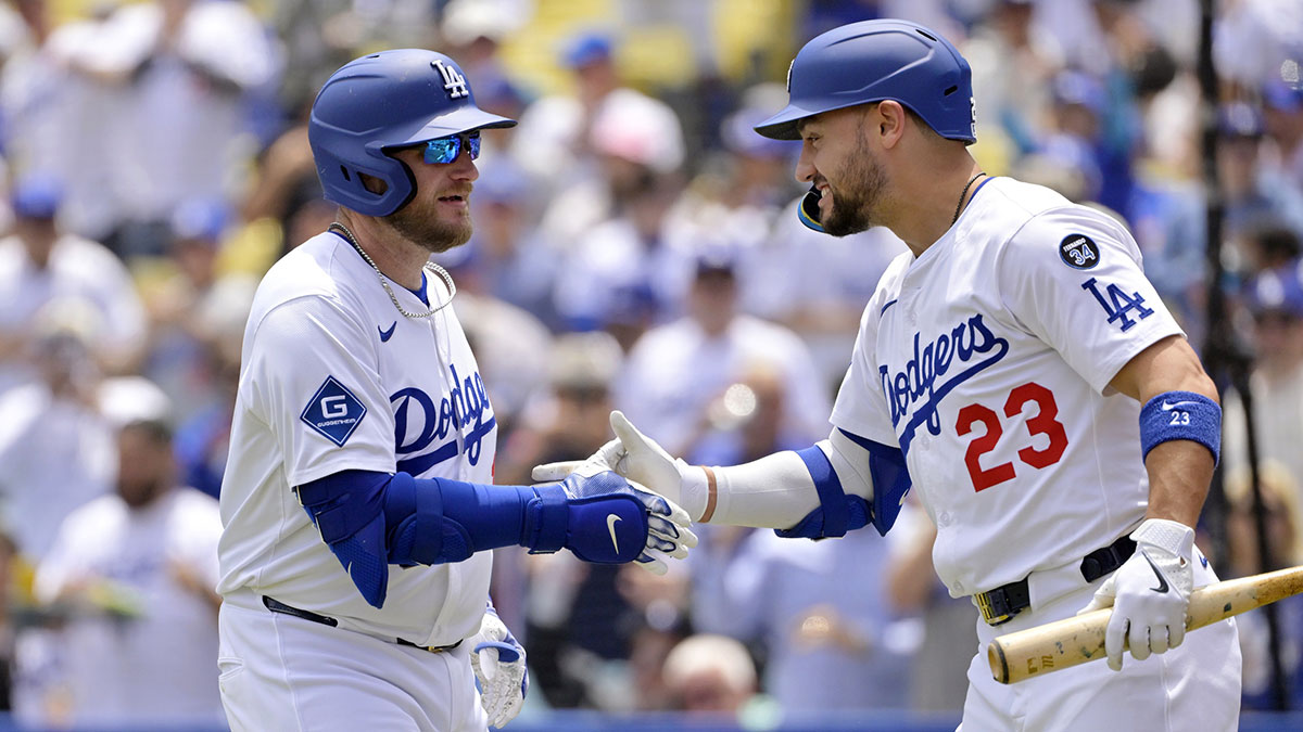 Los Angeles Dodgers third base Max Muncy (13) is congratulated by left fielder Michael Conforto (23) after hitting a home run against the Miami Marlins at Dodger Stadium.