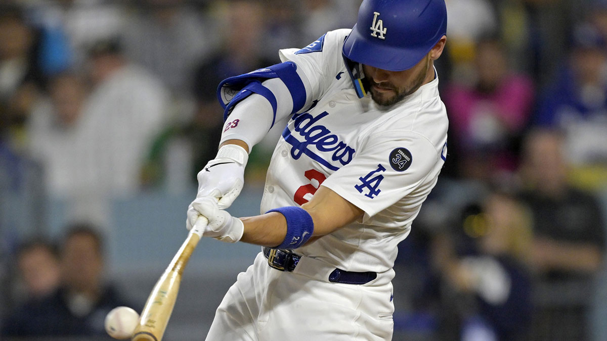 Los Angeles Dodgers left fielder Michael Conforto (23) doubles against the Athletics at Dodger Stadium.
