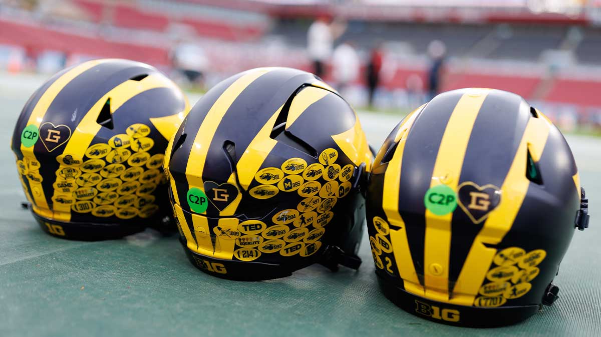 Michigan Wolverines quarterback helmets sit on the field before a game against the Alabama Crimson Tide at Raymond James Stadium.
