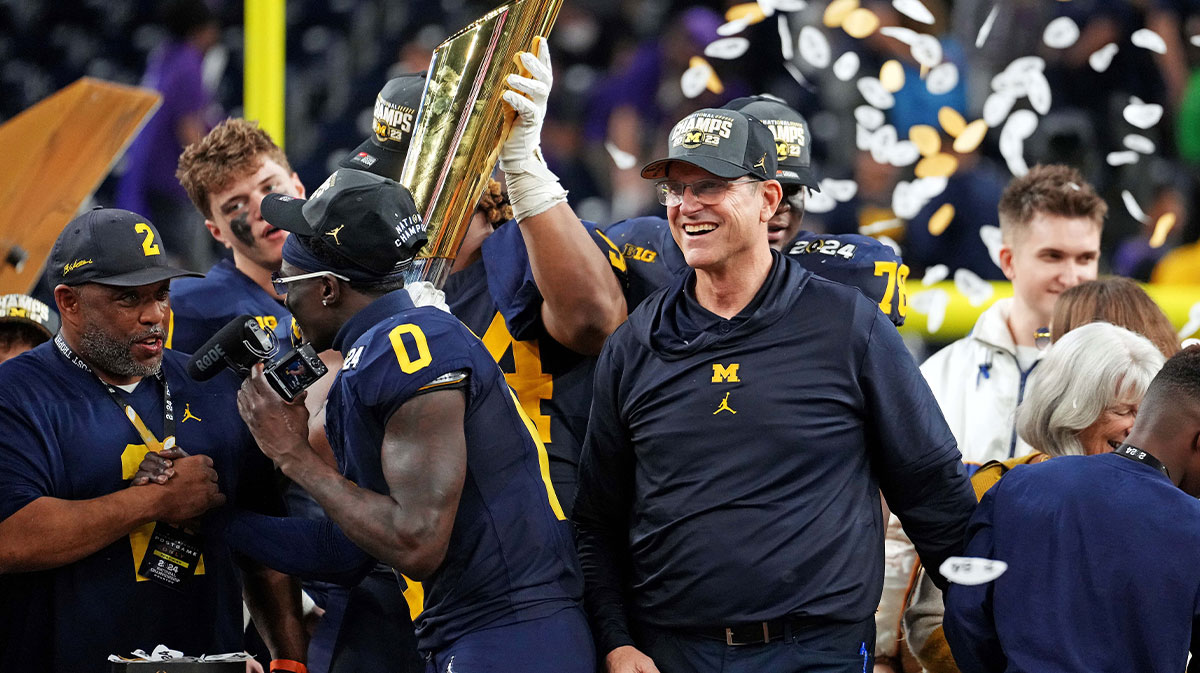 Michigan Wolverines head coach Jim Harbaugh celebrates with the CFP Championship trophy after beating the Washington Huskies in the 2024 College Football Playoff national championship game at NRG Stadium.