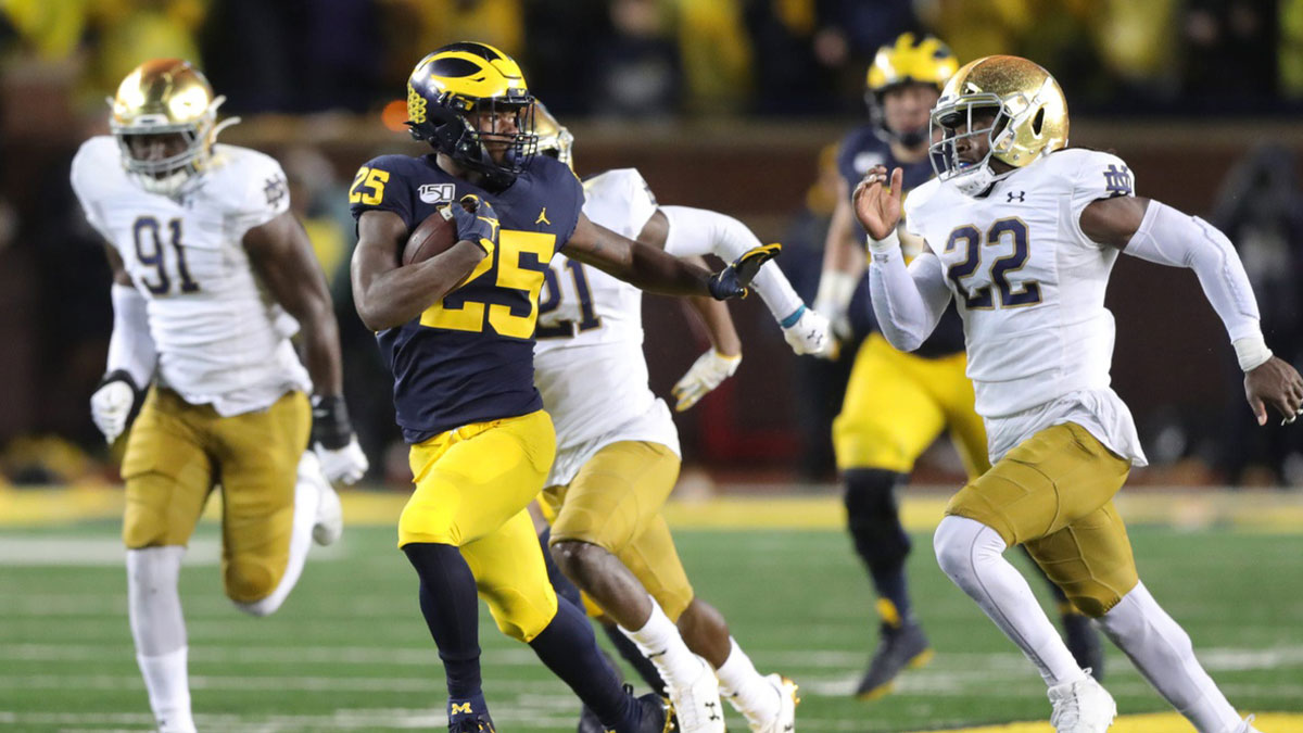 Michigan Wolverines running back Hassan Haskins runs by Notre Dame defenders during the second half