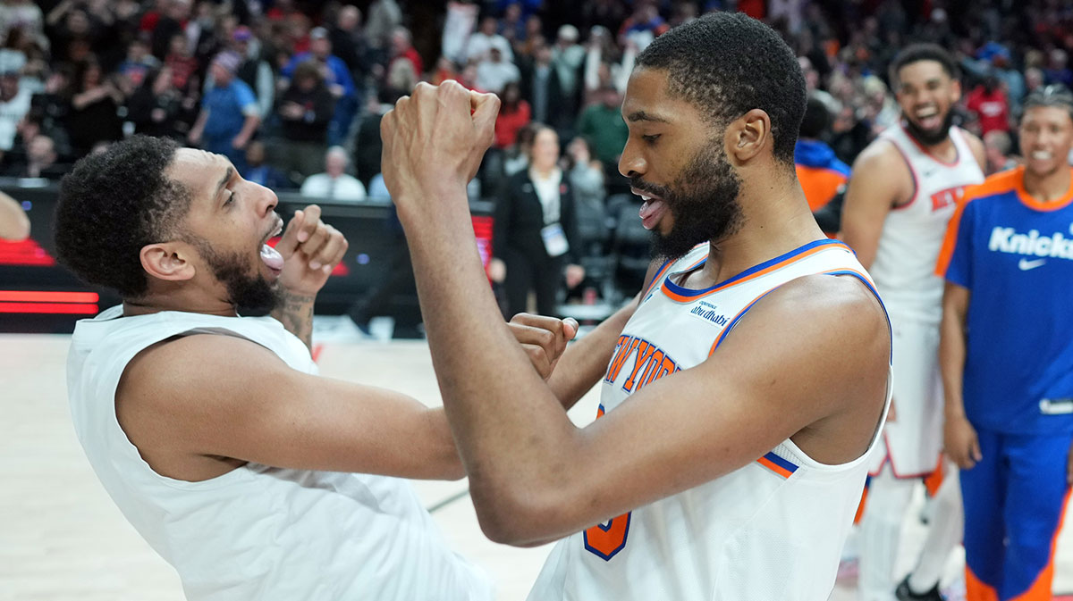 New York Knicks small forward Mikal Bridges (25, right) celebrates with guard Cameron Payne (1) after the game against the Portland Trail Blazers at Moda Center.