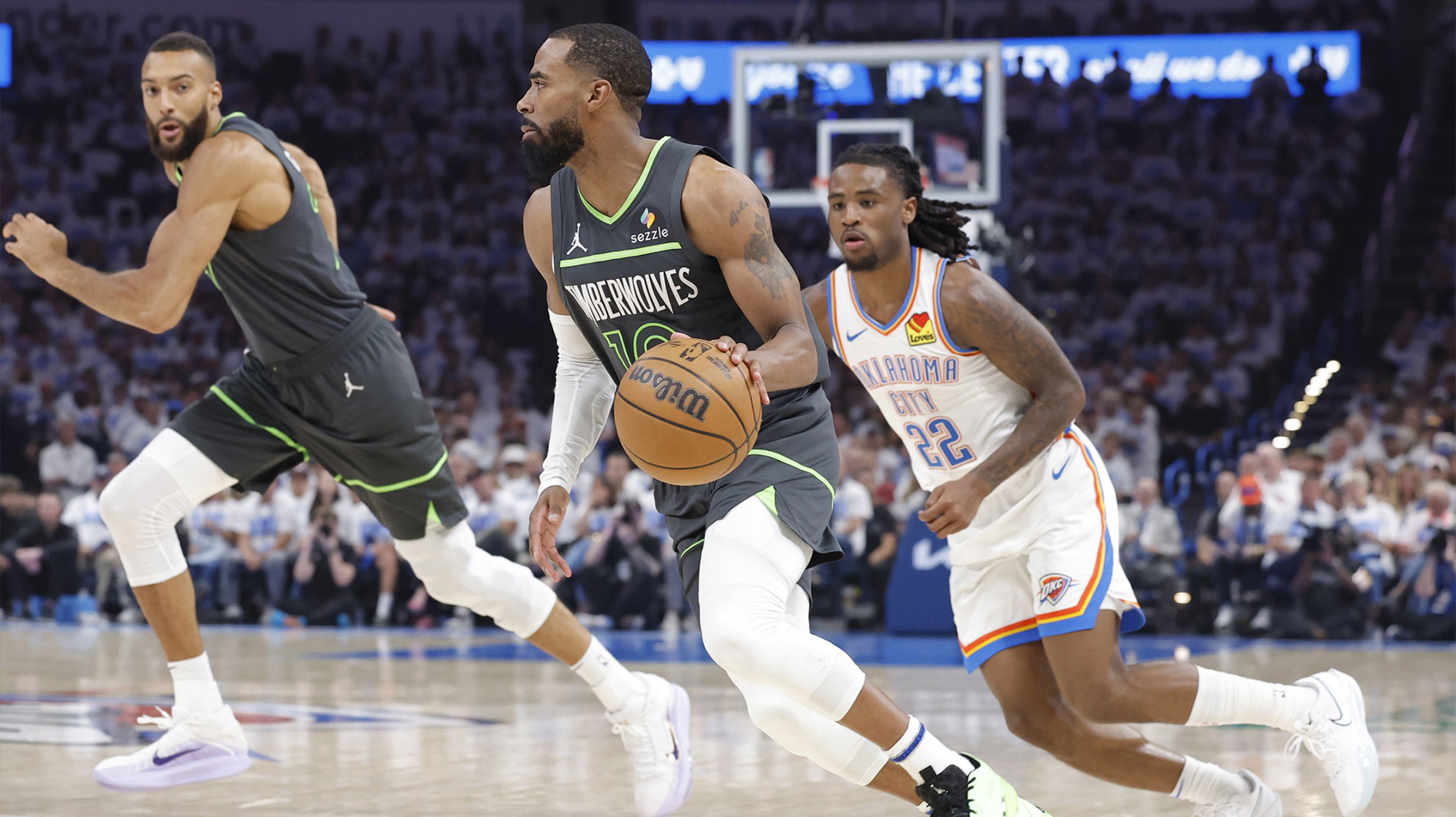 Minnesota Timberwolves guard Mike Conley (10) dribbles against Oklahoma City Thunder guard Cason Wallace (22) in the second quarter during game one of the western conference finals for the 2025 NBA Playoffs at Paycom Center.