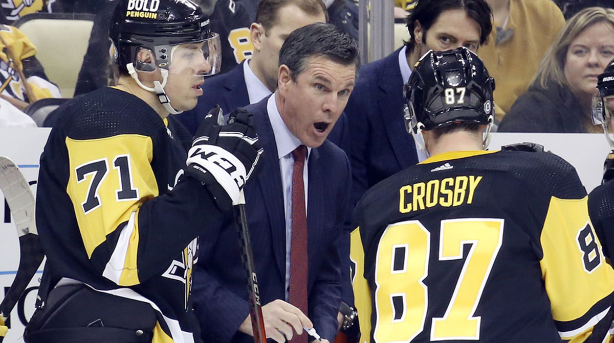 Pittsburgh Penguins head coach Mike Sullivan (middle) talks with Pittsburgh Penguins centers Evgeni Malkin (71) and Sidney Crosby (87) during a time-out against the Carolina Hurricanes in the third period at PPG Paints Arena.Carolina won 4-3.
