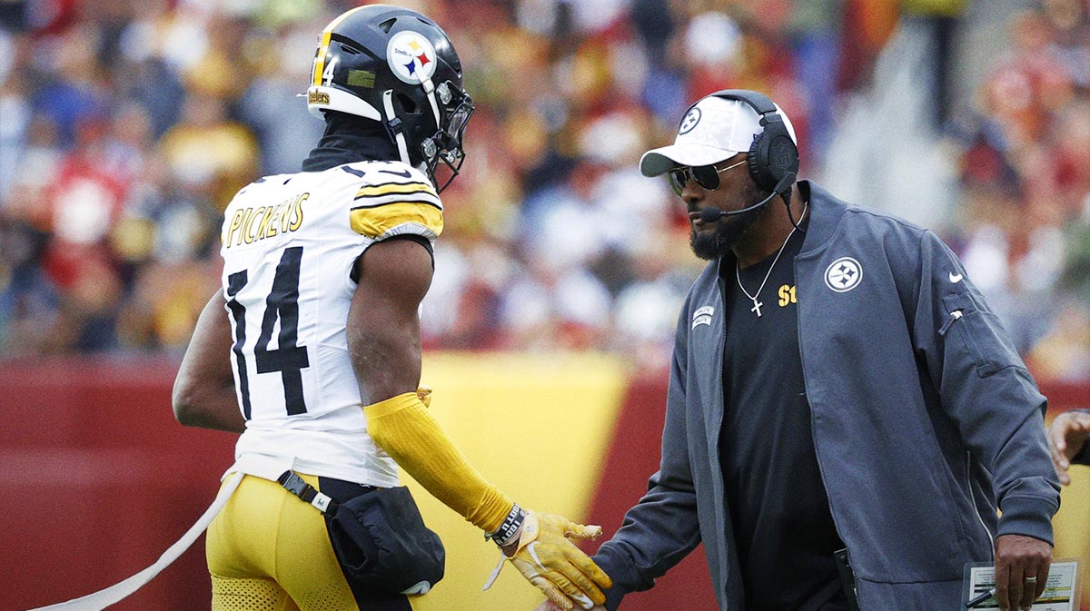 Pittsburgh Steelers head coach Mike Tomlin (R) congratulates Steelers wide receiver George Pickens (14) after a long catch against the Washington Commanders during the second half at Northwest Stadium.