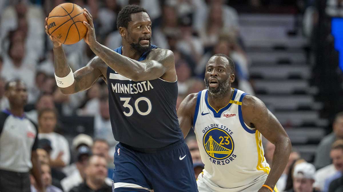 Minnesota Timberwolves forward Julius Randle (30) holds the ball as Golden State Warriors forward Draymond Green (23) plays defense in the second half during game five of the second round for the 2025 NBA Playoffs at Target Center.