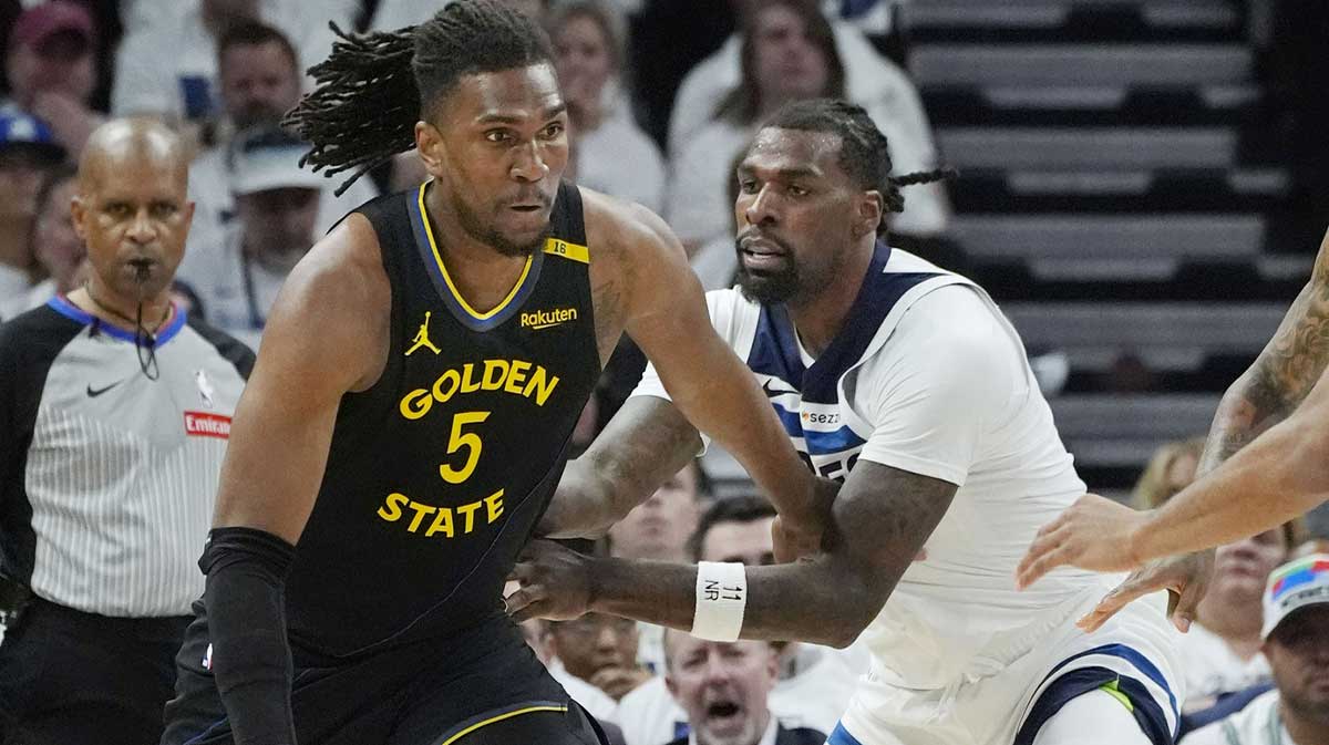 Golden State Warriors center Kevon Looney (5) dribbles against Minnesota Timberwolves center Naz Reid (11) in the first quarter during game one of the second round for the 2025 NBA Playoffs at Target Center.