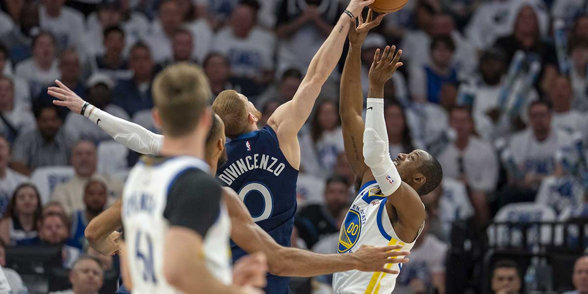 Minnesota Timberwolves guard Donte DiVincenzo (0) blocks a shot from Golden State Warriors forward Jonathan Kuminga (00) in the first half during game two of the second round for the 2025 NBA Playoffs at Target Center.