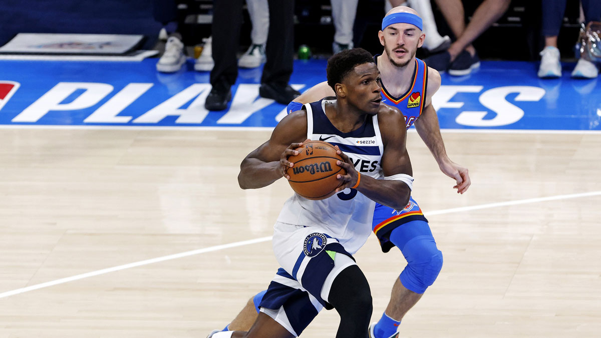 Minnesota Timberwolves guard Anthony Edwards (5) drives to the basket against Oklahoma City Thunder guard Alex Caruso (9) during the third quarter in game five of the western conference finals for the 2025 NBA Playoffs at Paycom Center.