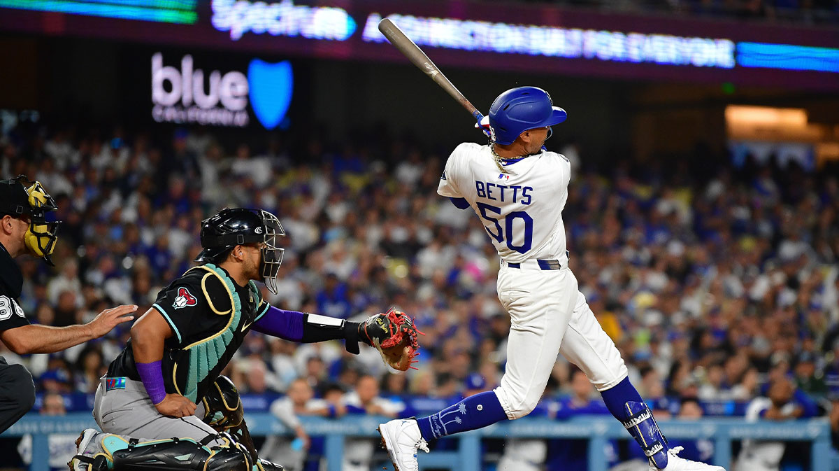 May 19, 2025; Los Angeles, California, USA; Los Angeles Dodgers shortstop Mookie Betts (50) hits a solo home run against the Arizona Diamondbacks during the fourth inning at Dodger Stadium.