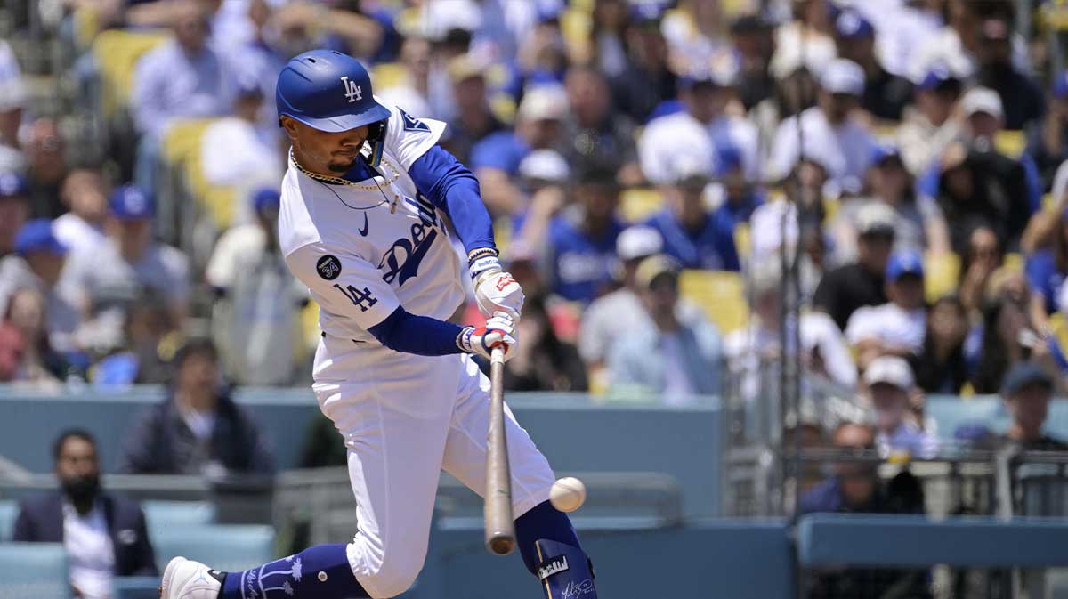 Los Angeles Dodgers shortstop Mookie Betts (50) hits a two-run RBI single against the Miami Marlins during the third inning at Dodger Stadium.