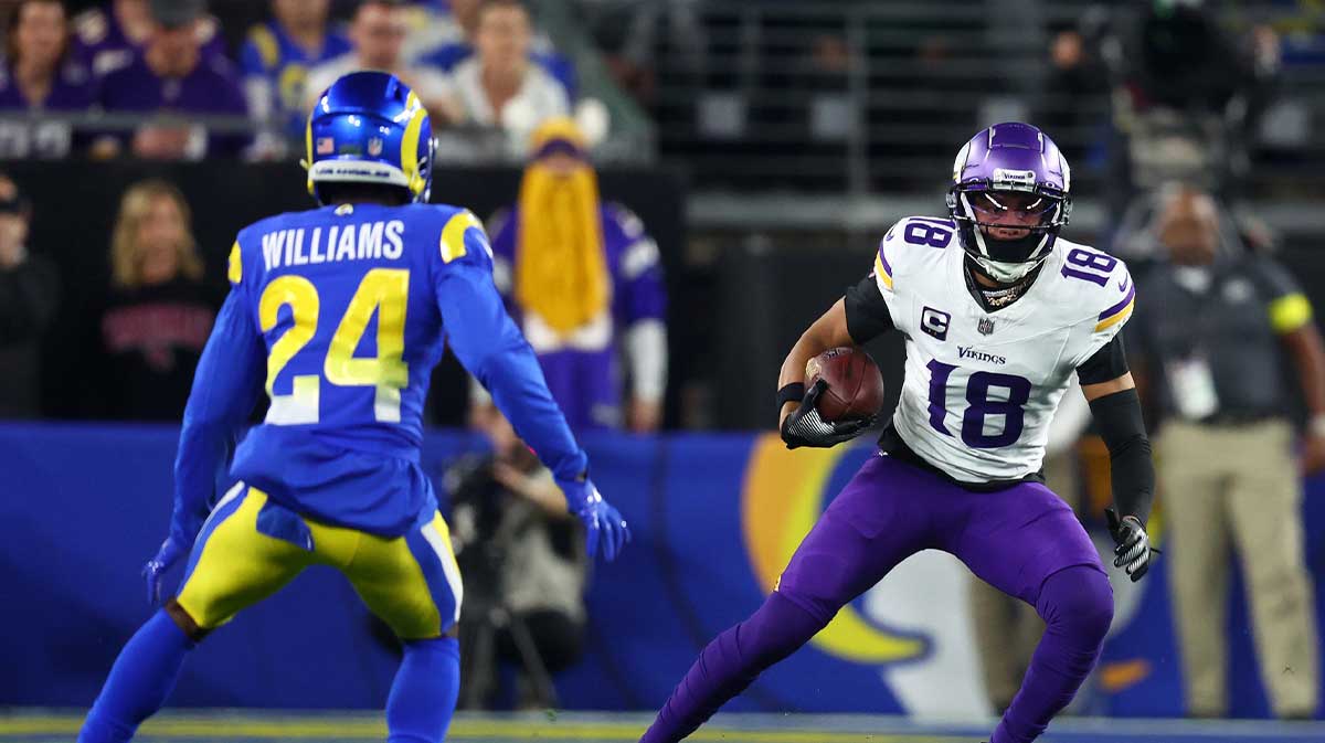 Minnesota Vikings wide receiver Justin Jefferson (18) makes a catch against Los Angeles Rams cornerback Darious Williams (24) during the first half in an NFC wild card game at State Farm Stadium.