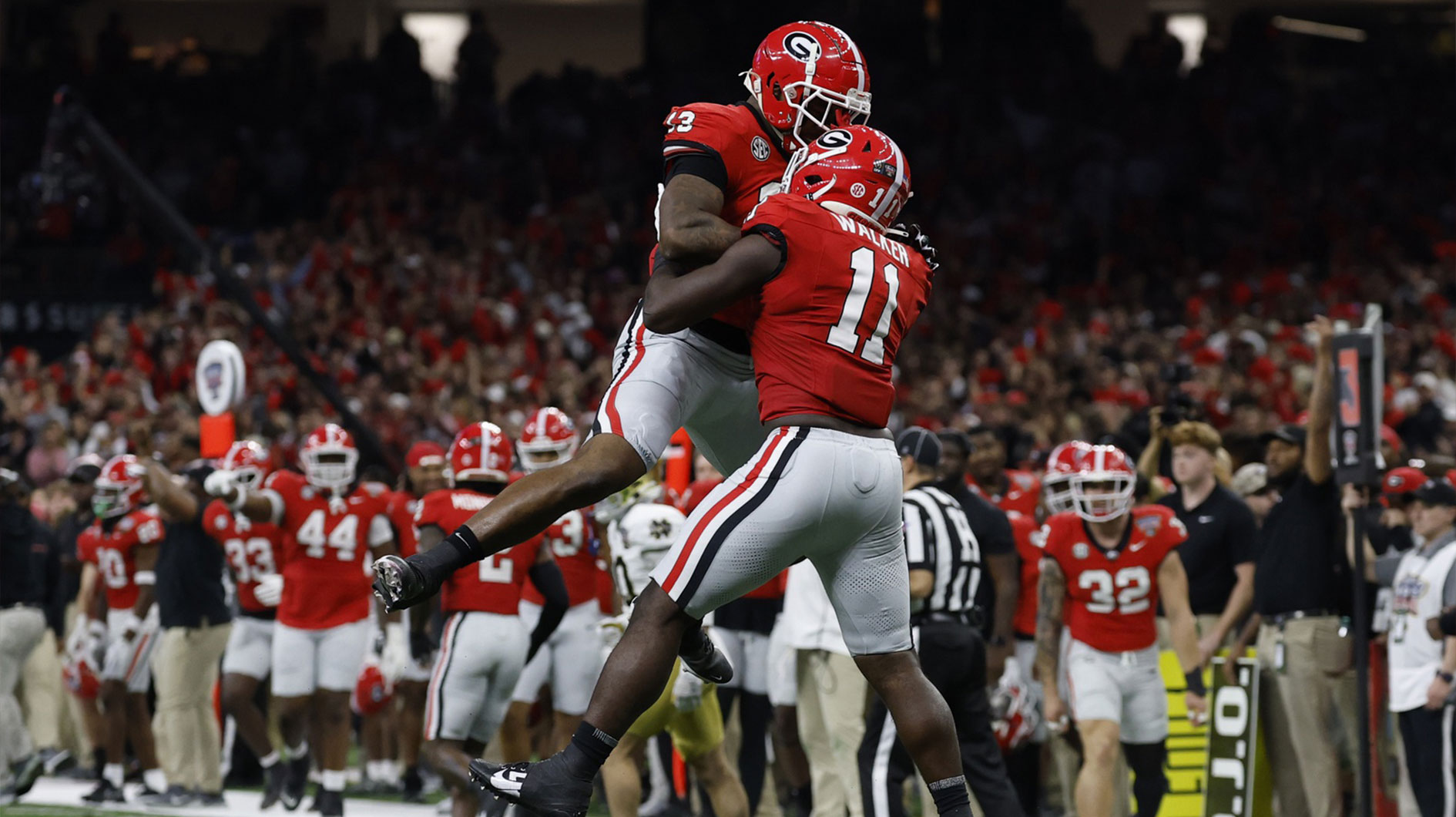 Georgia Bulldogs linebacker Jalon Walker (11) celebrates with Bulldogs defensive lineman Mykel Williams (13) after making a defensive stop against the Notre Dame Fighting Irish during the first quarter at Caesars Superdome.
