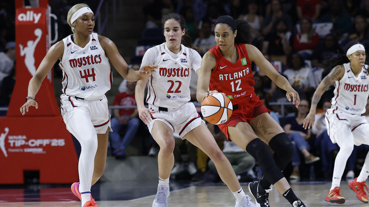 Atlanta Dream forward Nia Coffey dribbles the ball as Washington Mystics forward Kiki Iriafen and Mystics guard Sonia Citron defend in the second half at CareFirst Arena.