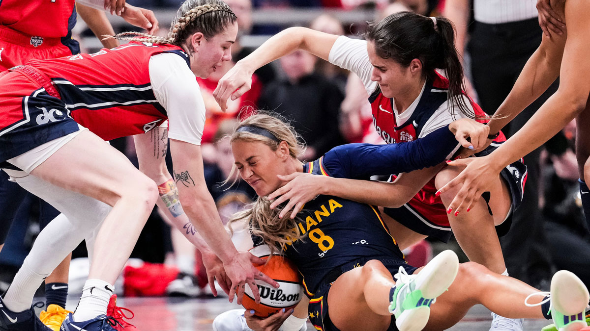 Washington Mystics Emily Engstler (21), Indiana Fever Sophie Cunningham (8) and Washington Mystics Sonia Citron (22) fight for a loose ball Saturday, May 3, 2025, during a preseason game between the Indiana Fever and the Washington Mystics at Gainbridge Fieldhouse in Indianapolis.