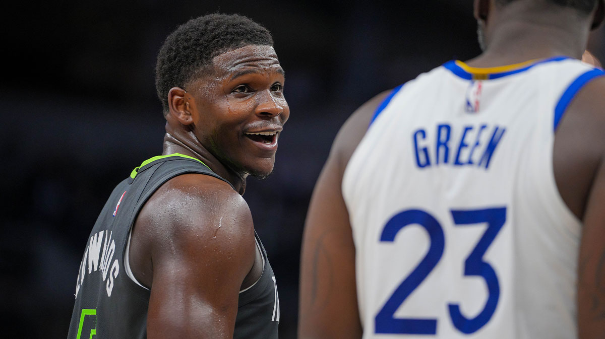 Minnesota Timberwolves guard Anthony Edwards (5) talks to Golden State Warriors forward Draymond Green (23) during a free throw in the third quarter at Target Center.