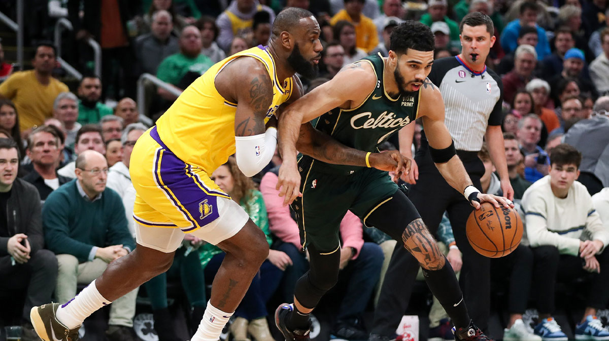 Boston Celtics striker Jayson Tatum (0) defended by the Los Angeles LeBron James (6) striker during the first half at TD Garden.