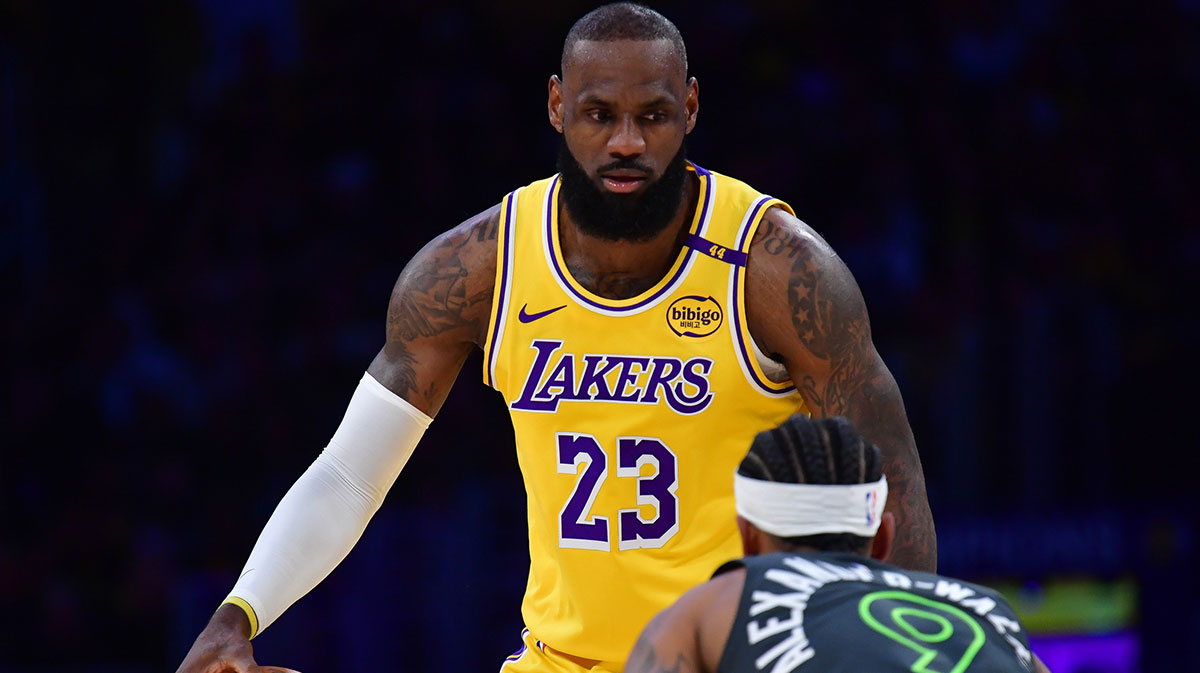 Los Angeles Lakers forward LeBron James (23) controls the ball against Minnesota Timberwolves guard Nickeil Alexander-Walker (9) during the first half in game five of first round for the 2025 NBA Playoffs at Crypto.com Arena.