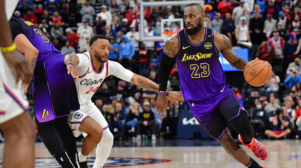 Los Angeles Lakers forward LeBron James (23) moves the ball as forward Anthony Davis (3) provides coverage against Los Angeles Clippers guard Norman Powell (24) during the second half at Intuit Dome.