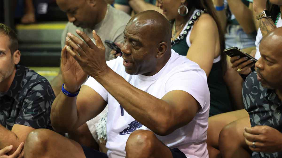 Former professional basketball player and Michigan State alumni, Earving “Magic” Johnson, center, watches the Colorado Buffaloes take on the Michigan State Spartans in the first half of an NCAA college basketball game at Lahaina Civic Center.