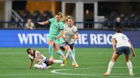 Kansas City Current midfielder Claire Hutton (14) jumps over Seattle Reign midfielder Sam Meza (20) during the second half at Lumen Field.