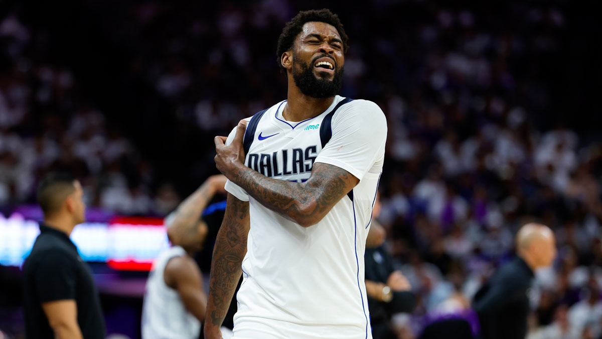 Dallas Mavericks forward Naji Marshall (13) exits the game while holding his shoulder during the second quarter against the Sacramento Kings at Golden 1 Center.