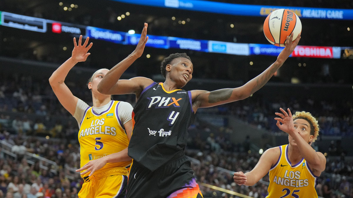 Phoenix Mercury forward Natasha Mack (4) reaches for the ball against LA Sparks forward Dearica Hamby (5) and guard Layshia Clarendon (25) in the first half at Crypto.com Arena.