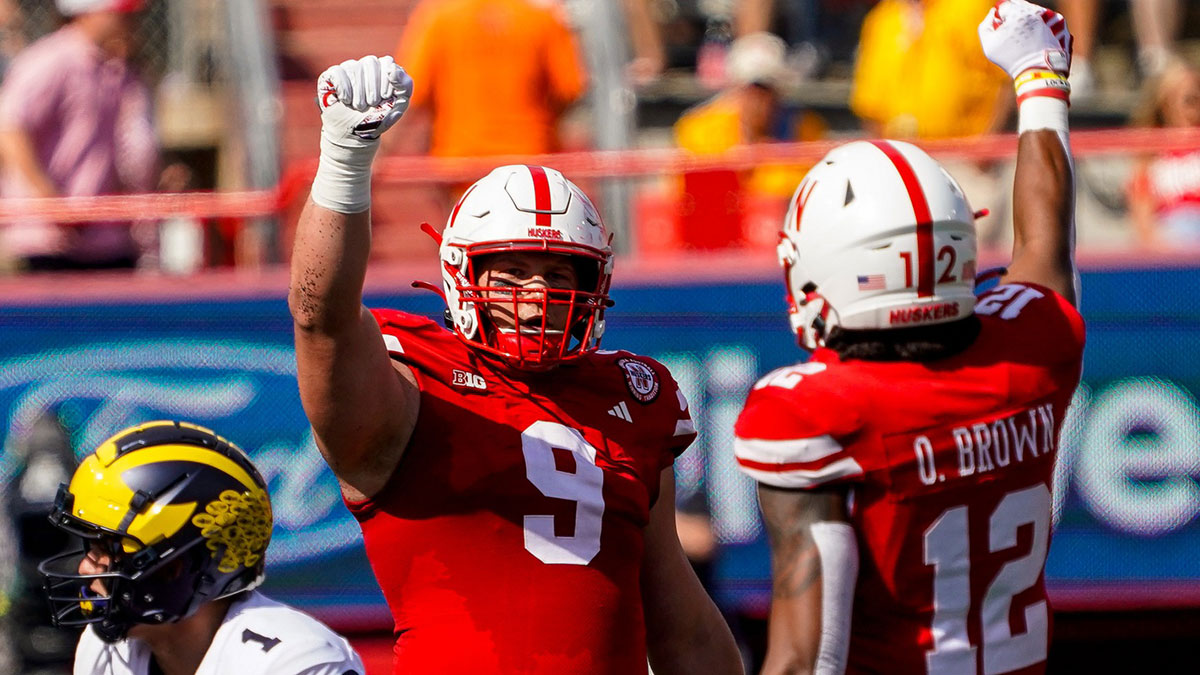 Nebraska Cornhuskers defensive lineman Ty Robinson (9) and defensive back Omar Brown (12) celebrate after a stop against the Michigan Wolverines during the first quarter at Memorial Stadium.