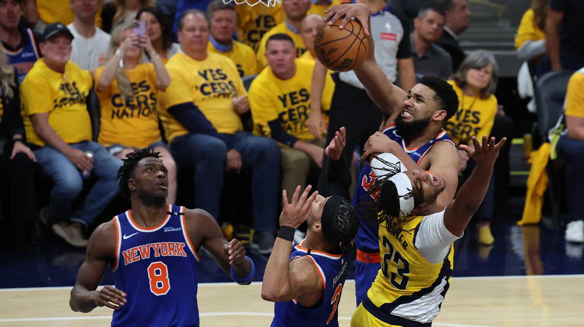 New York Knicks center Karl-Anthony Towns (32) drives to the hoop past Indiana Pacers center Myles Turner (33) during the fourth quarter of game four of the eastern conference finals for the 2025 NBA Playoffs at Gainbridge Fieldhouse.
