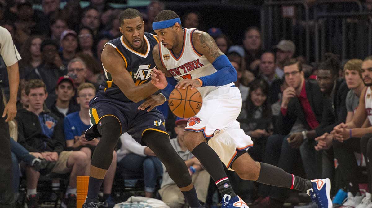 New York Knicks small forward Carmelo Anthony (7) dribbles the ball against Utah Jazz power forward Derrick Favors (15) during the third quarter at Madison Square Garden. Utah won 114-109.