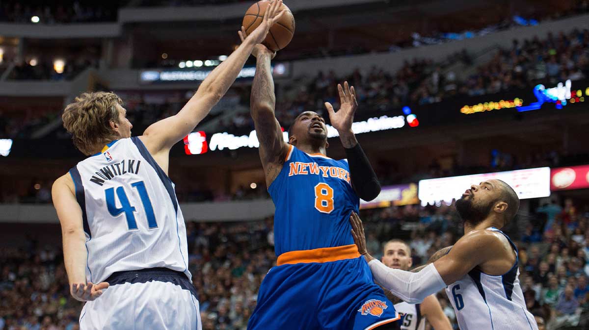 New York Knicks guard J.R. Smith (8) drives to the basket past Dallas Mavericks forward Dirk Nowitzki (41) and center Tyson Chandler (6) during the first half at the American Airlines Center.