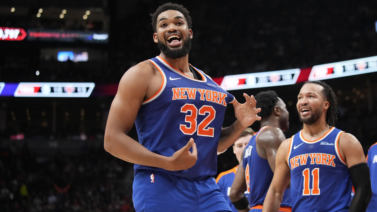 New York Knicks guard Jalen Brunson (11) watches as center Karl-Anthony Towns (32) celebrates after making a three point basket to clinch a win against the Toronto Raptors near the end of the fourth quarter at Scotiabank Arena.