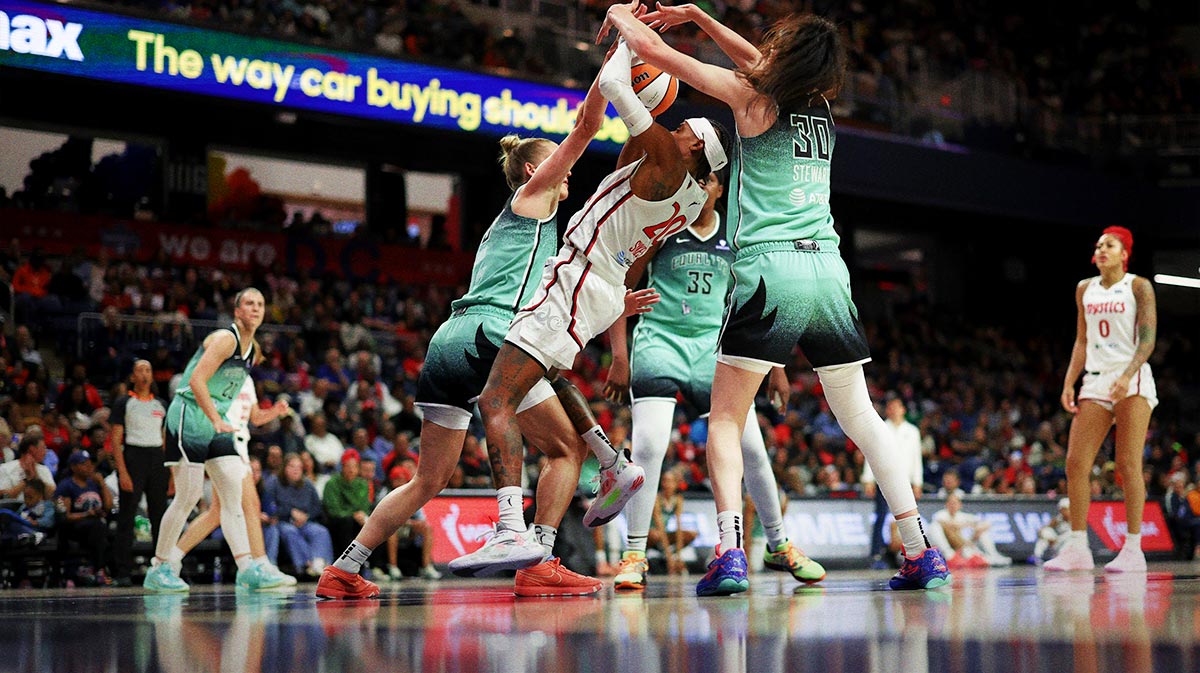 Washington Mystics guard Brittney Sykes (20) attempts to shoot the ball as New York Liberty forward Leonie Fiebich (13) and Liberty forward Breanna Stewart (30) defend in the second half at CareFirst Arena.