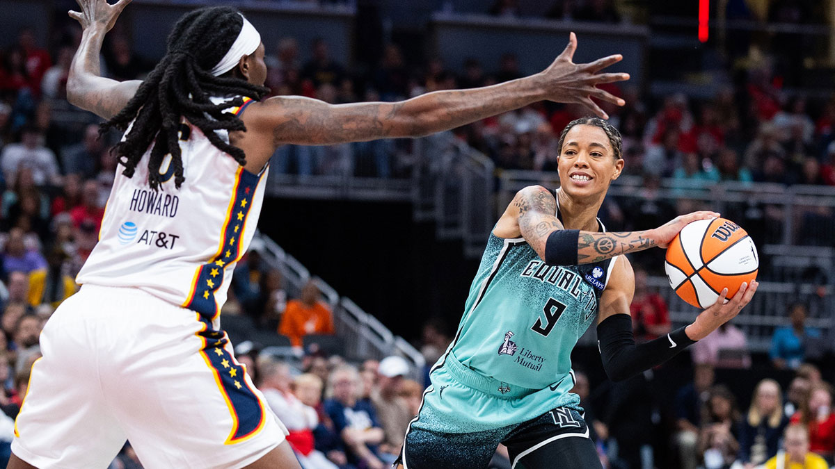 New York Liberty guard Natasha Cloud (9) passes the ball while Indiana Fever forward Natasha Howard (6) defends in the first half at Gainbridge Fieldhouse.