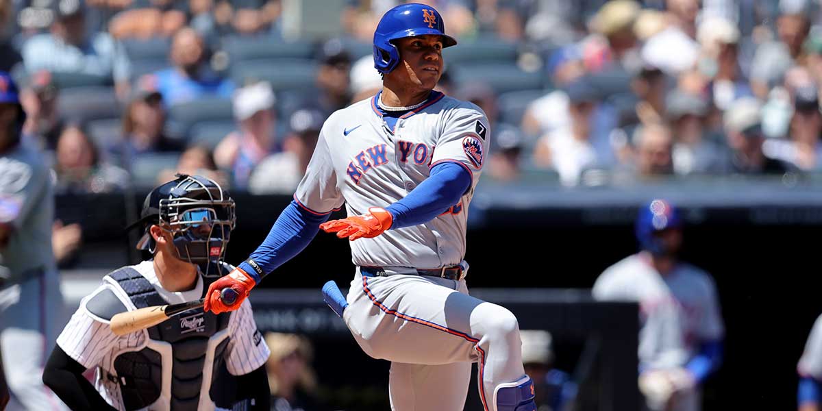 New York Mets right fielder Juan Soto (22) follows through on a single against the New York Yankees during the fourth inning at Yankee Stadium.
